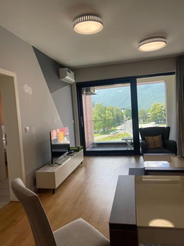 a living room with a couch and a table and a tv at ilidza sky river 2 in Sarajevo