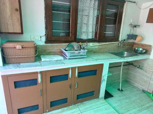 a kitchen with a sink and a counter top at Ashiana in Patiāla