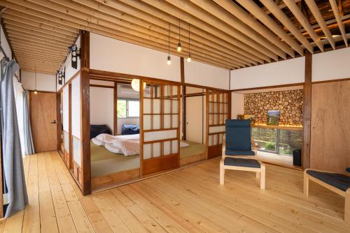 a room with a bunk bed and a chair at The Whale House 日光 by Silver Daisy in Nikko