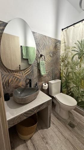 a bathroom with a sink and a toilet and a mirror at PANDORA Φουρνοι Κορσεων in Nisída Foúrnoi