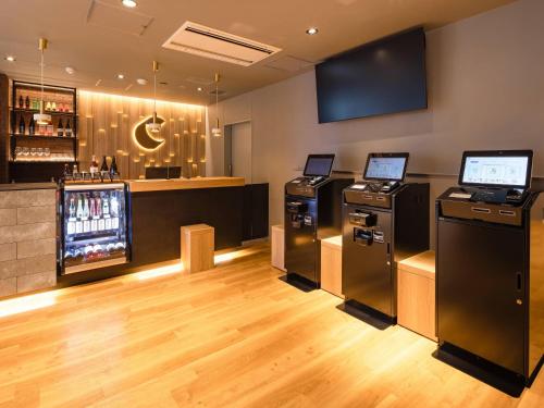 a bar with two arcade machines in a room at Comfort Hotel ERA Sapporo North in Sapporo