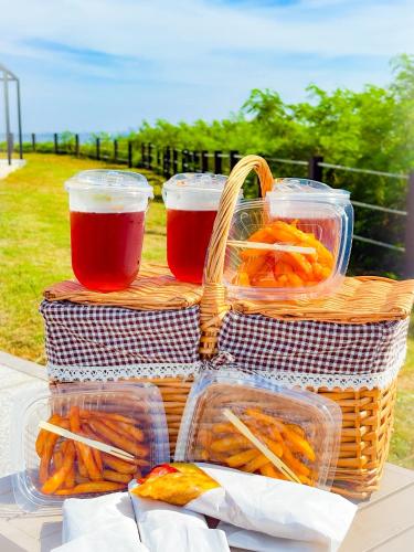 three baskets of food and two glasses of beer at Bay Hill Camping Area in Magong