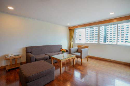 a living room with a couch and a table at The Mercer Sukhumvit 4 in Bangkok