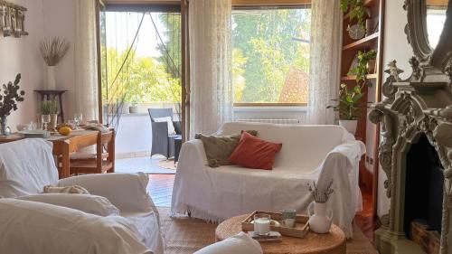 a living room with a white couch and a fireplace at ECO - Villa Giulia in Dormelletto