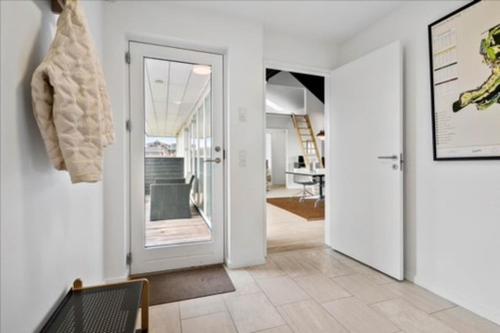 a hallway with a door leading to a living room at Lübker Golf Resort in Nimtofte