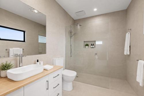 a bathroom with a shower and a toilet and a sink at Mercer on Port in Portarlington