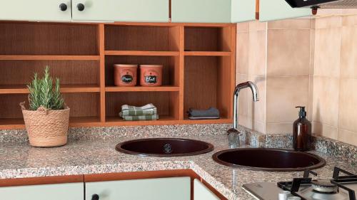 a kitchen with a sink and a counter top at ECO - Villa Giulia in Dormelletto