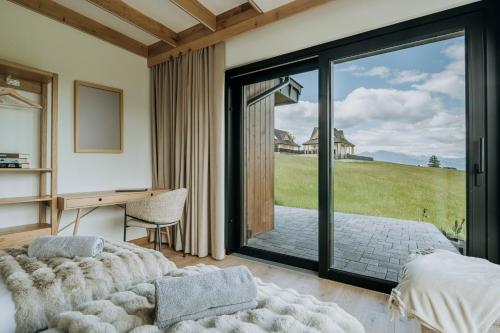a bedroom with a bed and a desk and a window at Matygowa Osada in Gliczarów Górny