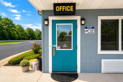 a blue office building with a blue door at Relax Inn Dover Near Speedway in Dover