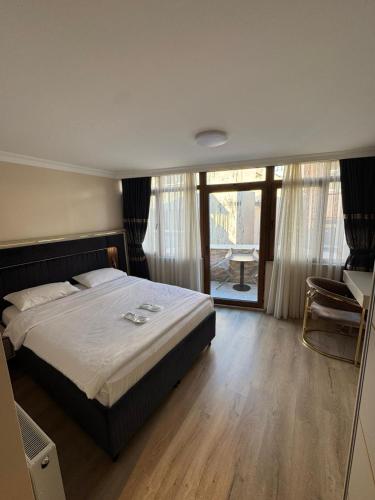 a bedroom with a bed and a large window at New Hotel Harbiye Studio in Istanbul