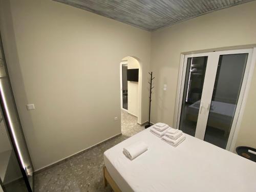 a room with two beds and a mirror at Mu Caza Monemvasia in Monemvasia