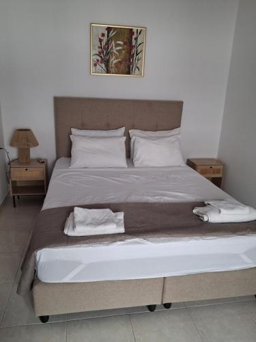 a bedroom with a large bed with two towels on it at IRINIS HOUSES in Rhodes Town