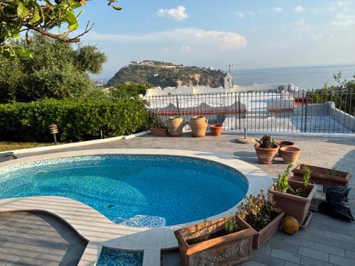 a swimming pool with a view of the ocean at VILLA CLARA ISCHIA piscina riscaldata e idromassaggio in Lacco Ameno