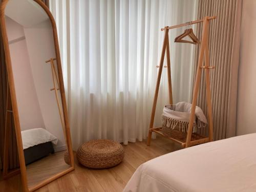 a bedroom with a mirror and a bed and a chair at Newly Renovated Japandi 1BR Near Shangri-La in Ulaanbaatar