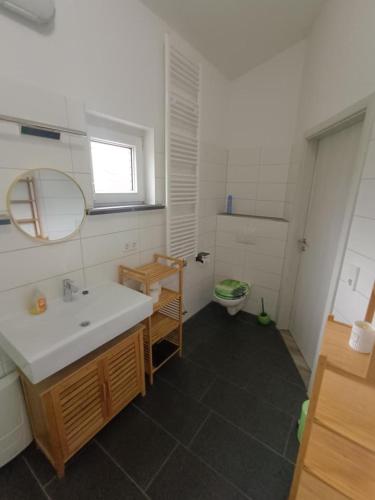a bathroom with a sink and a toilet at NEU! Ferienhaus Schwedt in Schwedt