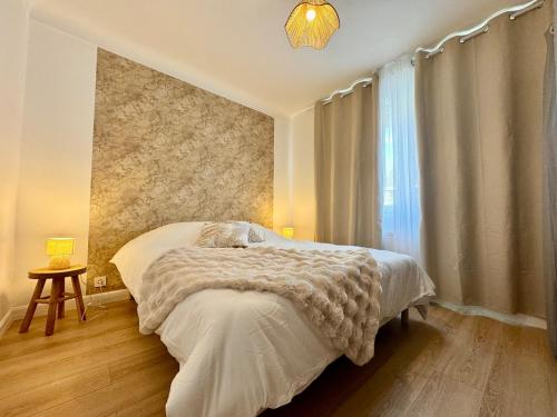 a bedroom with a bed and a window at Le Cocon Doré in Calais