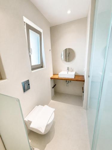 a bathroom with a toilet and a sink at Lucevista Mykonos Villas in Fanari