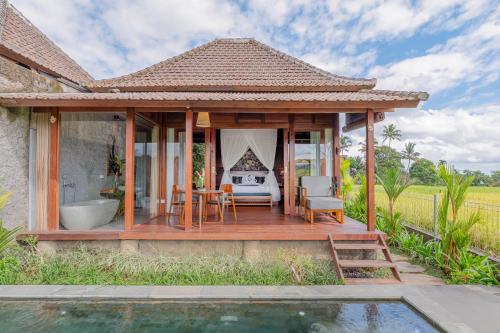 a villa with a pool and a house at Aranya Ubud Villa in Ubud
