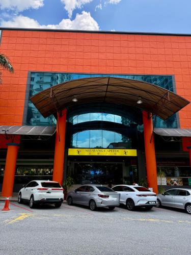 a building with cars parked in front of it at Agape Hotel Selayang in Batu Caves