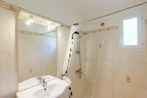 a bathroom with a sink and a shower at Le Figuier - La Fontinelle in Bessas
