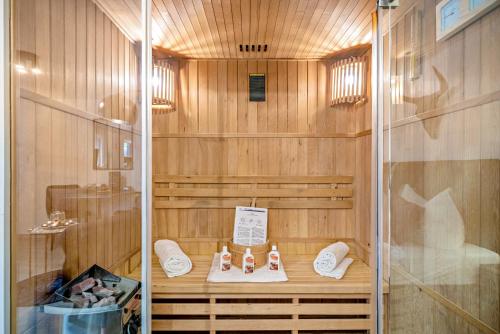 a sauna with wooden walls and white shoes in it at Eifel-Dream Kalkmulde in Fleringen