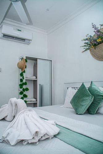 a bedroom with a bed with a robe on it at Mbuyu Taifa Greenview Mlandege Apartment in Zanzibar City