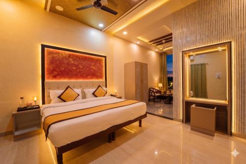 a bedroom with a bed with a painting on the wall at Thar Exotica Hotel & Resort Bikaner in Bikaner