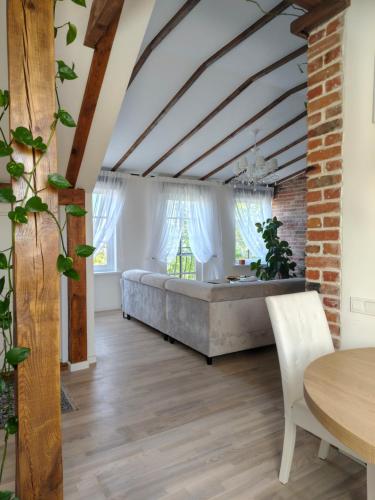 a living room with a large bed and a table at Pliusas Residence in Jurbarkas