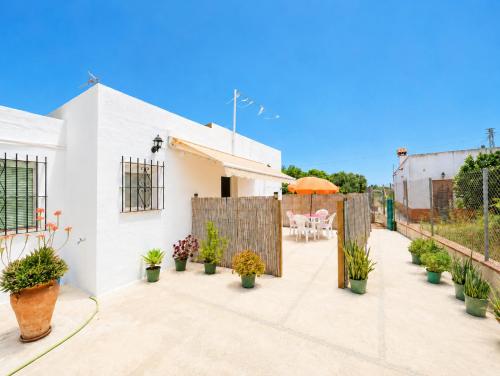 a patio with potted plants and a fence at Casa de Los Arbolitos in El Palmar