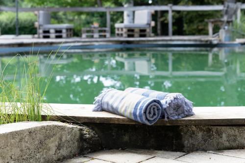 a towel sitting on a bench next to a swimming pool at Ferienwohnung Bodensee 2 in Meßkirch