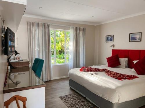 a bedroom with a large bed and a window at Blue Bend Valley in East London