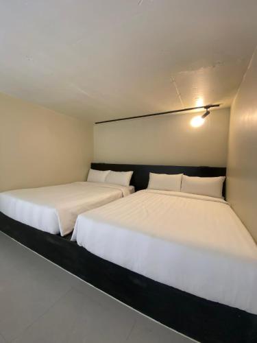two beds sitting next to each other in a room at Cafe Itaewon Pool & Villa in Sampong