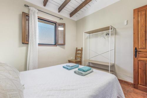 a bedroom with a white bed and a glass shower at Casa Villazo 1 in Málaga