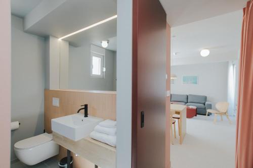 a bathroom with a sink and a toilet at áPero Suites in Trogir