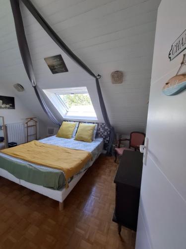 a bedroom with a bed in a attic at Villa Cap Avalenn in Fouesnant