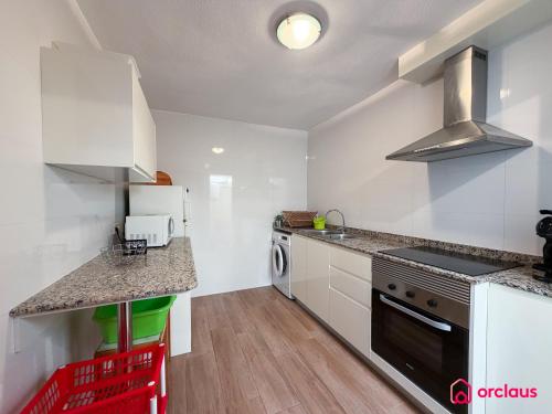 a kitchen with a sink and a stove top oven at House Bloom in Oropesa del Mar