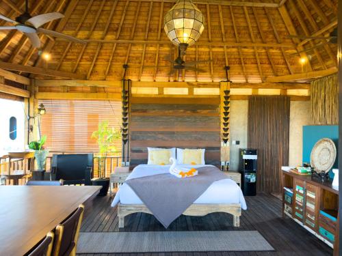 a bedroom with a bed and a wooden ceiling at Beachview Villa near Sanur, Live Sports AFL NRL in Ketewel