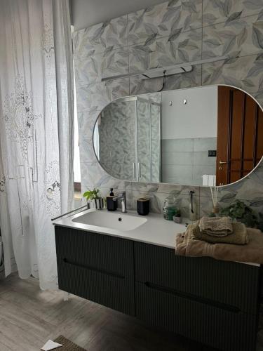 a bathroom with a sink and a mirror at Domus Relax in Battipaglia