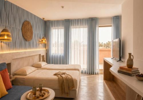a hotel room with a bed and a television at Casablanca Hotel - All Inclusive in Obzor