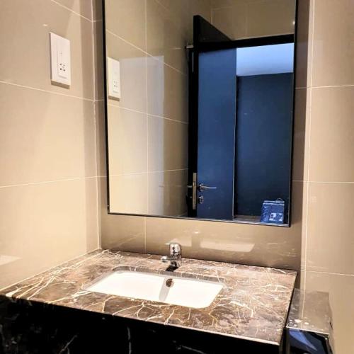 a bathroom with a sink and a mirror at family 1 bed room apartment in Malacca