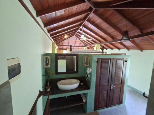 a bathroom with a sink and a mirror at The Spice House Mirissa in Mirissa