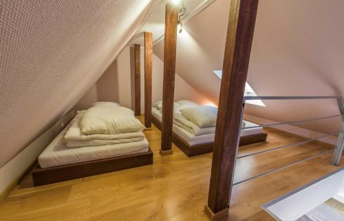 two beds in a room with a staircase at Apartament Giżycko in Giżycko