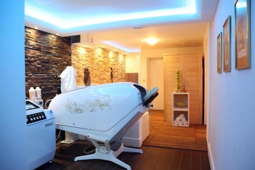 a bath tub in a room with a hair salon at ApartHotel Vila Minka in Ljubljana
