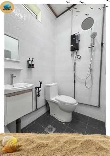 a bathroom with a shower and a toilet and a sink at Aqua Vista Merang in Kampung Merang