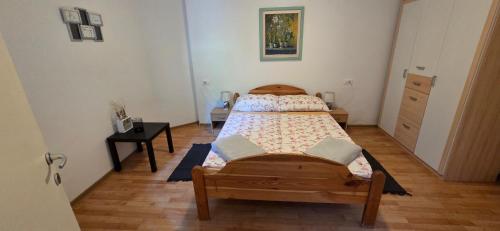 a bedroom with a bed and a dresser in it at Apartments Violeta in Bled