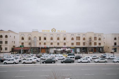 a parking lot in front of a large building at Dendi hotel bukhara in Bukhara