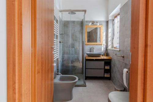 a bathroom with a shower and a sink and a toilet at La Ruetta in LʼAquila
