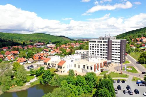 an aerial view of a town with a river and buildings at Hasseröder Burghotel in Wernigerode