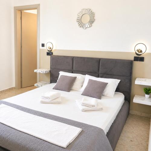 a bedroom with a large bed with two pillows at Endless Green Villa in Argostoli