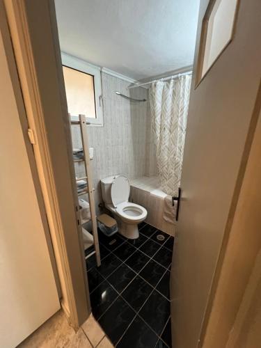 a bathroom with a toilet and a bath tub at Home Sweet Home AXD in Alexandroupoli